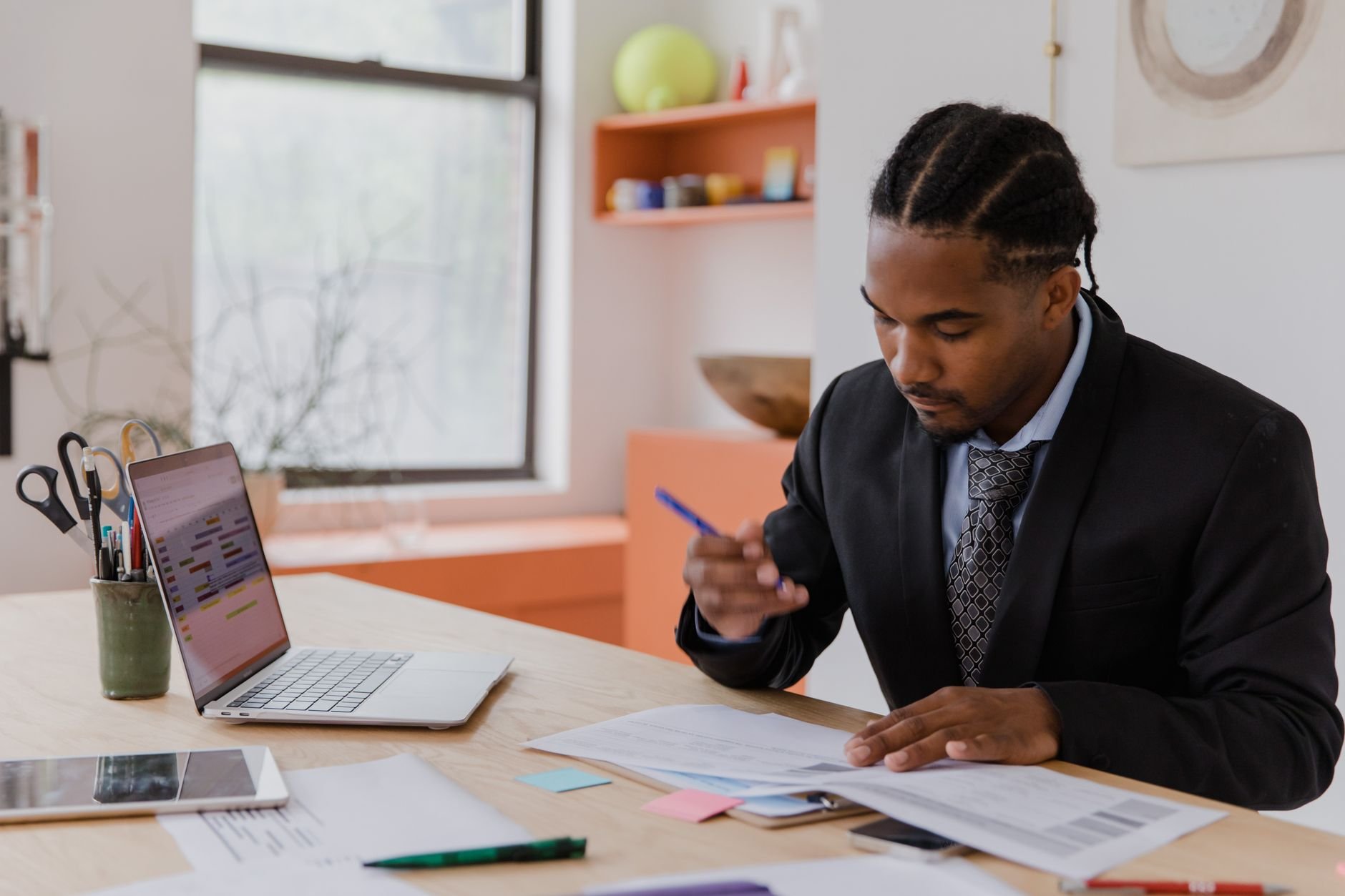 A professional businessman reviewing documents and operational plans at his desk